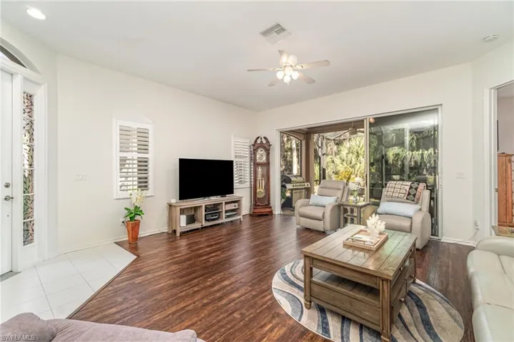 Living room featuring wood finished floors and a ceiling fan