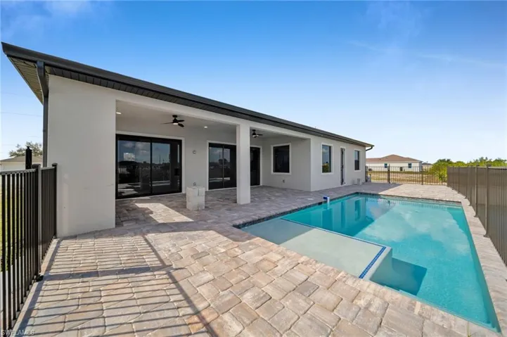 Back of house featuring ceiling fan, a fenced backyard, a patio, and stucco siding