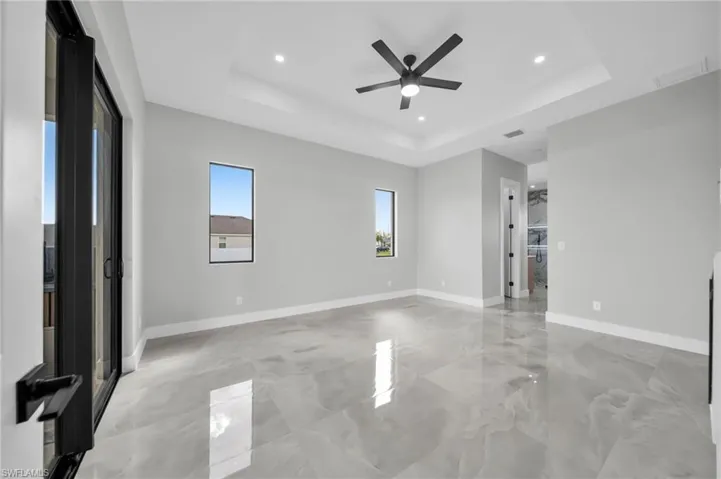 Spare room featuring ceiling fan, recessed lighting, and a raised ceiling
