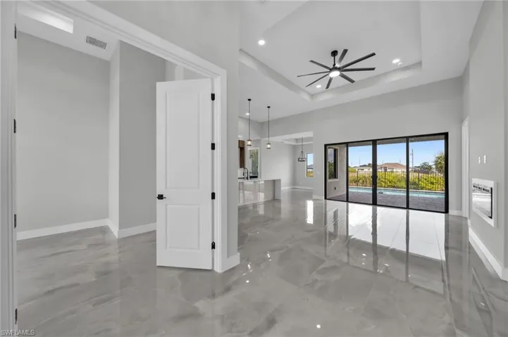 Spare room with ceiling fan, recessed lighting, and a tray ceiling