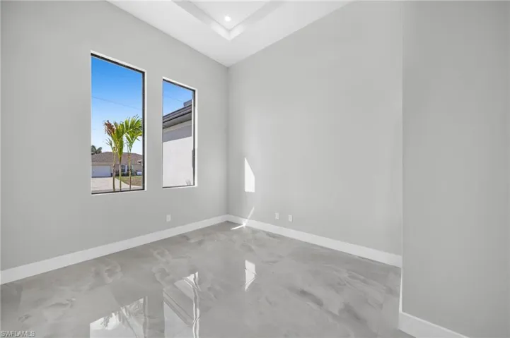 Spare room featuring baseboards and recessed lighting