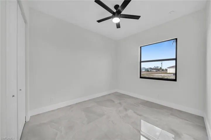 Unfurnished bedroom with a closet and ceiling fan
