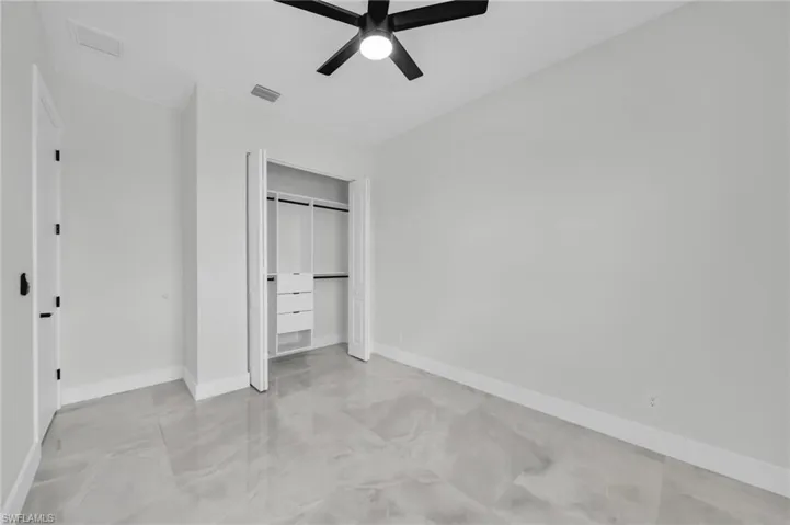 Unfurnished bedroom with a closet and ceiling fan