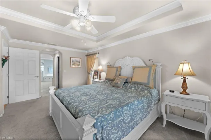 Master bedroom w/hall leading to closets and ensuite bath