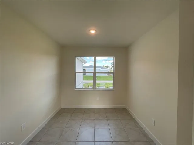 Unfurnished room with light tile patterned flooring
