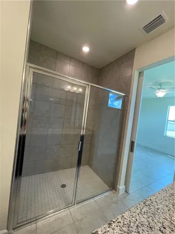 Bathroom featuring walk in shower and tile patterned floors