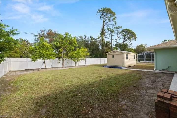 View of yard with a storage unit