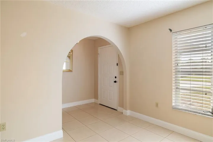 Foyer entrance featuring light tile patterned floors and a textured ceiling