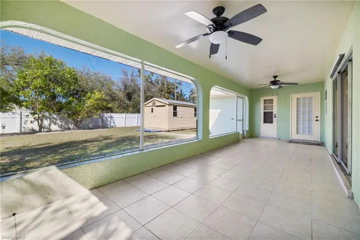 Unfurnished sunroom with a ceiling fan