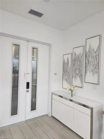 Hallway featuring french doors