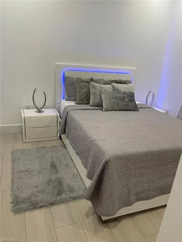 Bedroom with hardwood / wood-style flooring