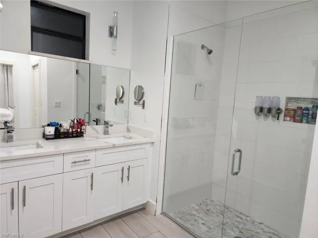 Bathroom featuring walk in shower and vanity