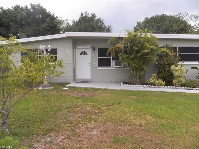 Single story home with a front yard