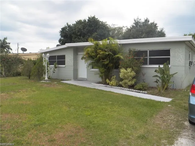 Back of house featuring a lawn