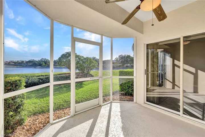 Unfurnished sunroom featuring ceiling fan and a water view