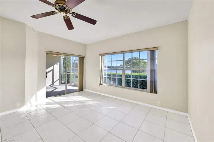 Spare room with ceiling fan and light tile patterned flooring