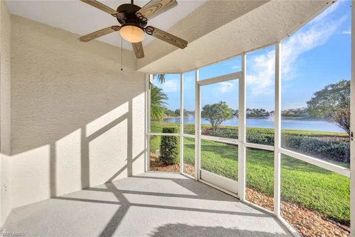 Unfurnished sunroom featuring ceiling fan and a water view