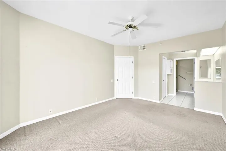 Unfurnished room with light carpet and ceiling fan