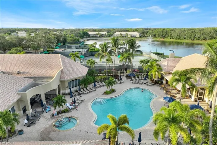 View of swimming pool with a water view and a patio