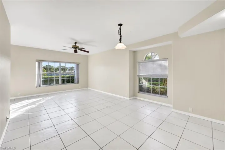 Tiled empty room featuring ceiling fan