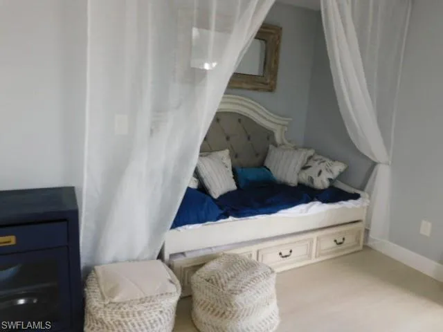 Bedroom with baseboards and light wood-type flooring