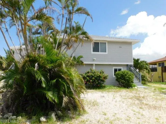 View of side of property with stairs