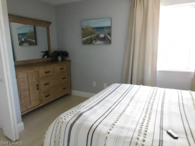 Bedroom featuring light wood finished floors and baseboards