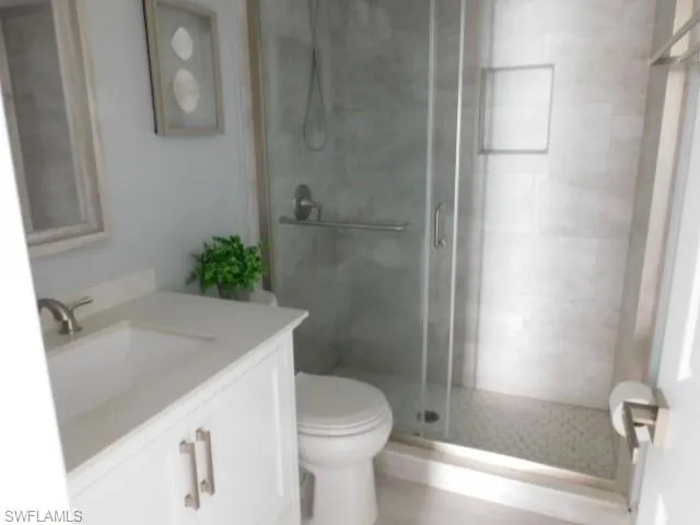 Bathroom with vanity and a stall shower