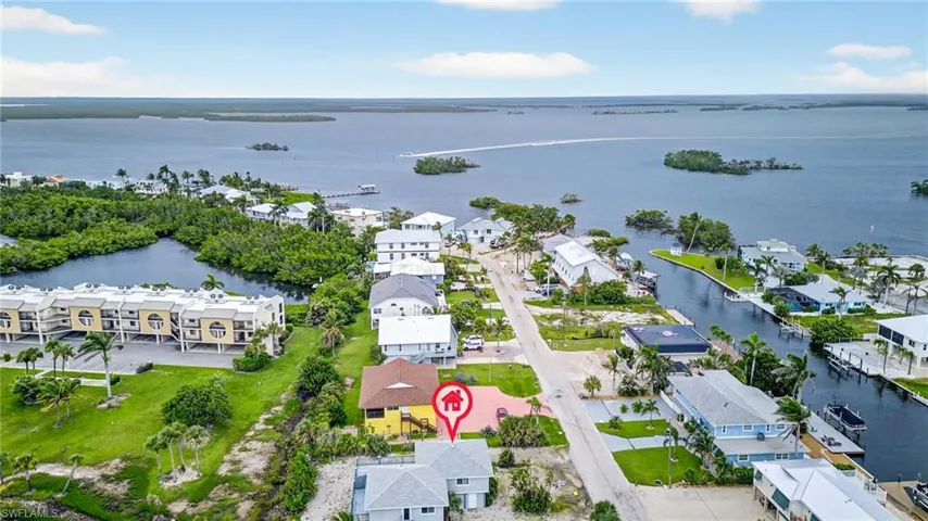 Aerial perspective of suburban area featuring a large body of water