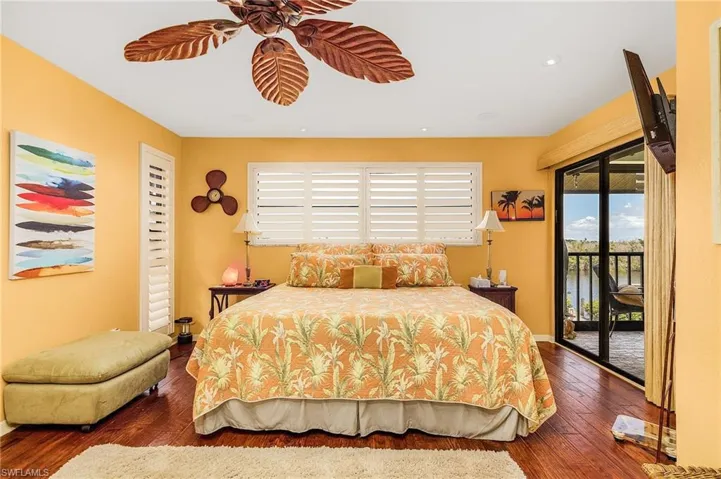 Bedroom with access to outside and dark wood-type flooring