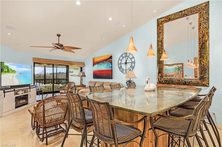 Tiled dining space featuring vaulted ceiling and ceiling fan