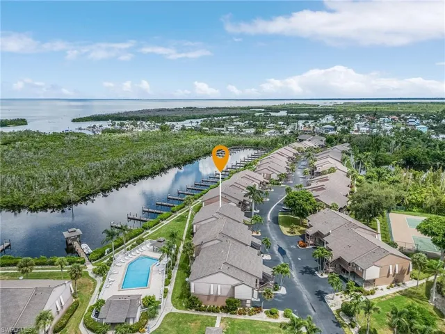 Birds eye view of property with a water view