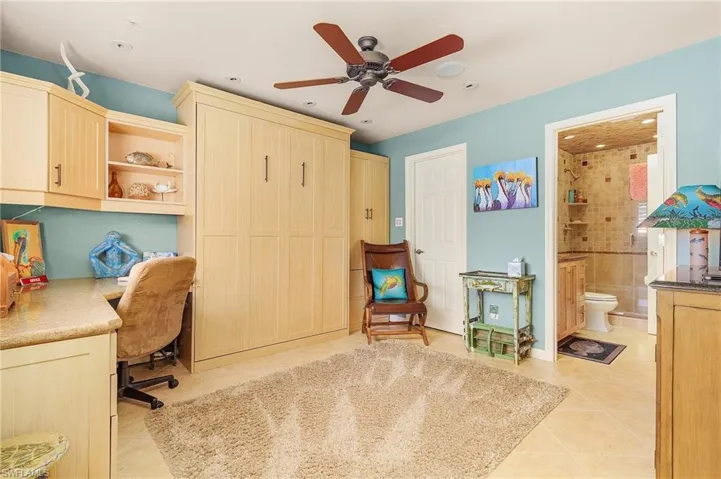 Tiled office space featuring ceiling fan