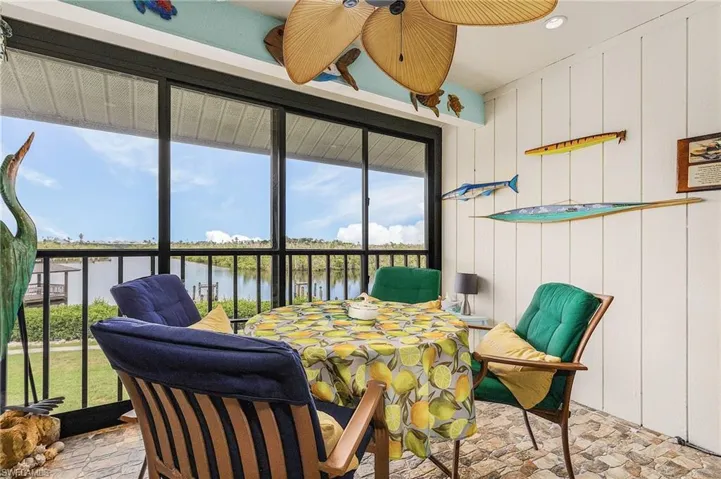 Sunroom / solarium featuring a wealth of natural light and a water view