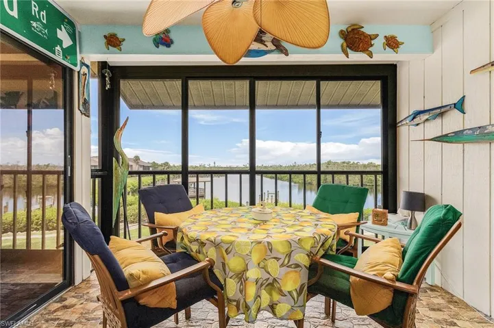 Sunroom featuring a water view, plenty of natural light, and ceiling fan