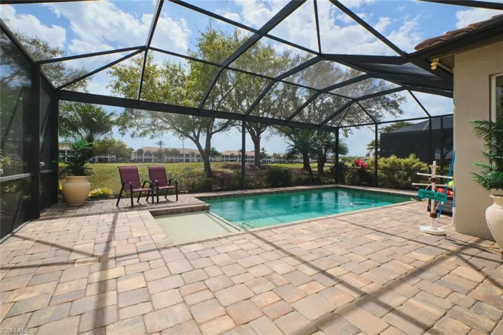 Outdoor pool with a sunroom, a patio, and a lanai