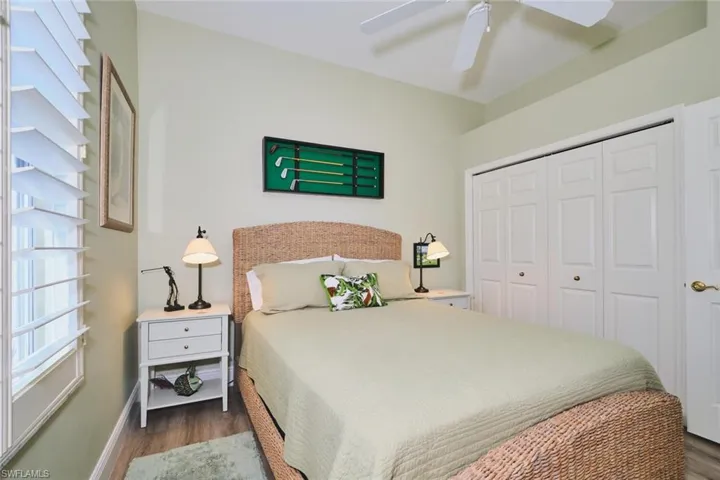 Bedroom featuring ceiling fan, wood finished floors, and a closet
