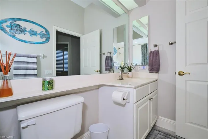 Half bathroom featuring vanity and toilet