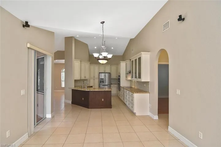 Kitchen featuring decorative light fixtures, tasteful backsplash, High End appliances, and light tile floors