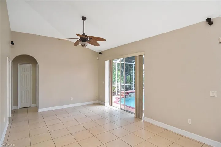 Spacious Family room with vaulted ceiling and sliding glass doors to pool area