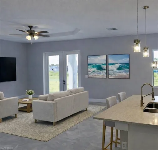 Living room featuring a ceiling fan, healthy amount of natural light, and french doors