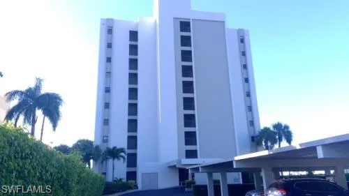 View of property with covered parking