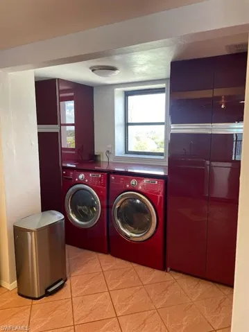 Clothes washing area featuring washer and dryer