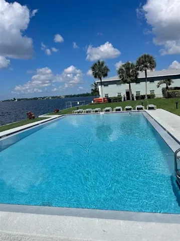 Community pool featuring a yard