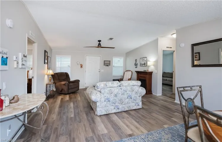 Large living area with high ceiling and LVP flooring