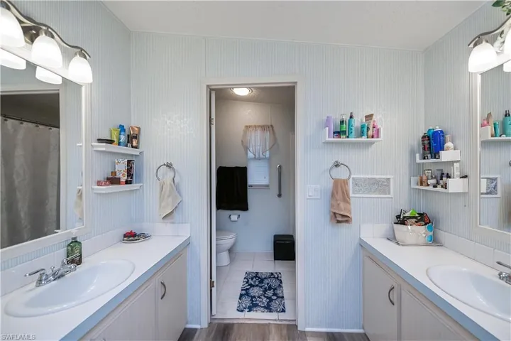 Full bathroom with separate vanities