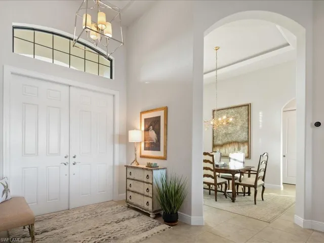 Tiled entrance foyer featuring a high ceiling and an inviting chandelier