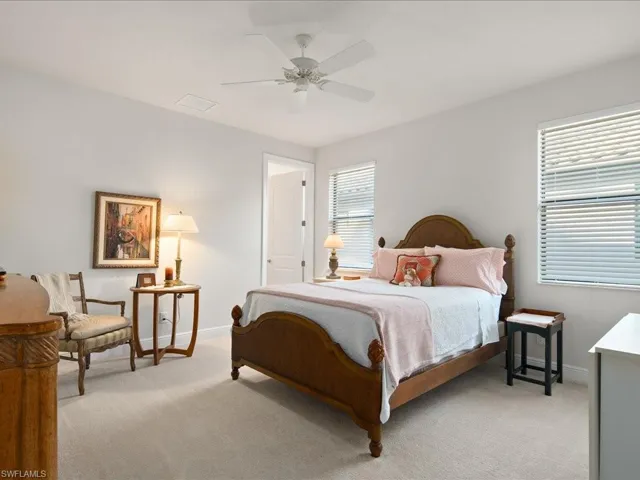 Carpeted bedroom with ceiling fan