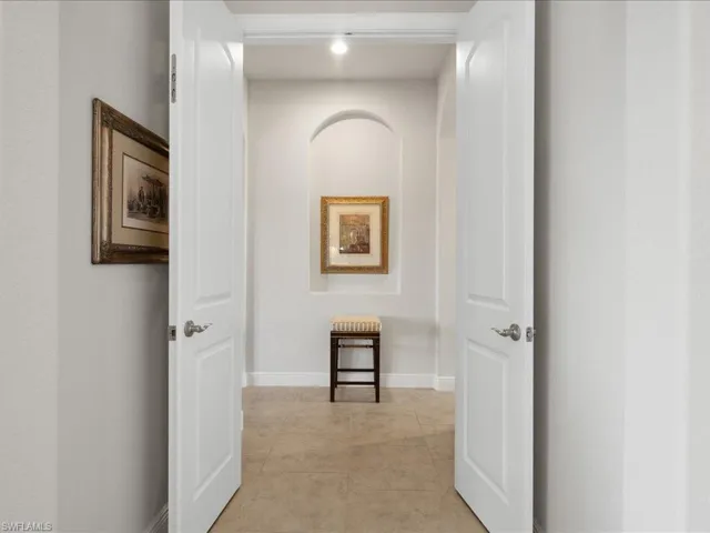 Hall featuring light tile patterned floors