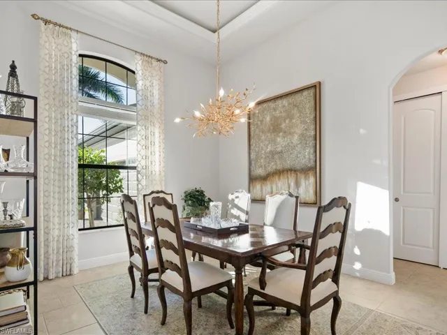 Tiled dining space with a chandelier